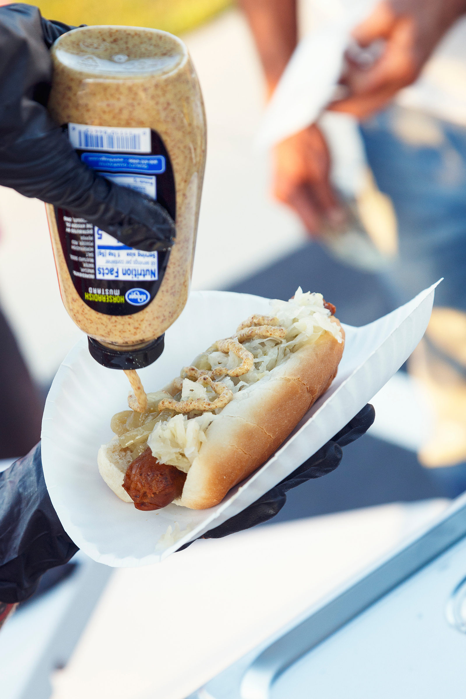 hot dog, mustard, outside, vendor, yellow, brown