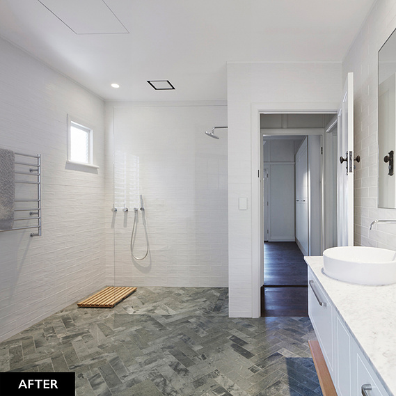 White, spacious, modern bathroom with open concept shower and two circular sinks