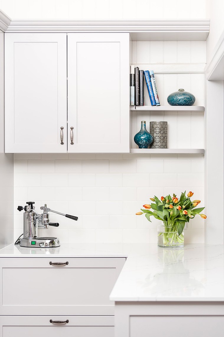 White, modern kitchen with colourful tulips on the counter