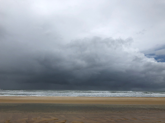 Dark, stormy skies over a beach scene