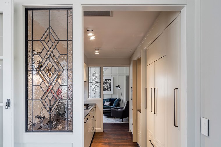 White kitchen with dark wooden floors