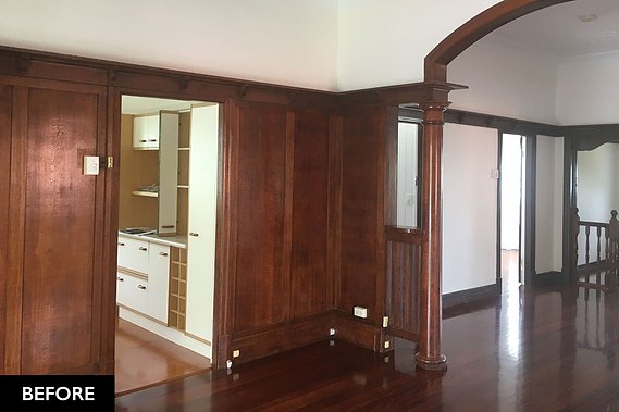 Dark, wooden interior walls with outdated kitchen decor.