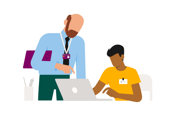An employee explains the tasks to be performed to a young apprentice in training.
