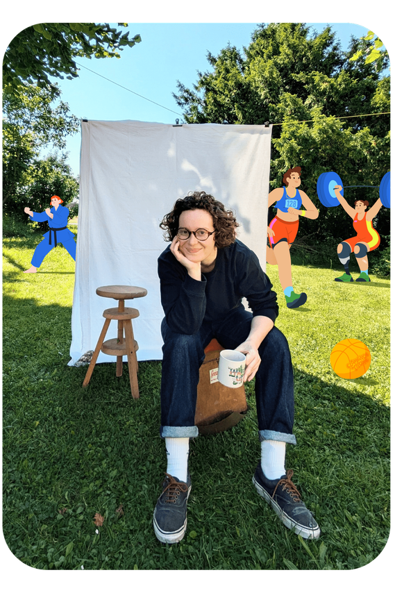Photo of designer and illustrator Clémence Thune in her sunny garden. She's relaxed and smiling. Her characters come to life in the background.
