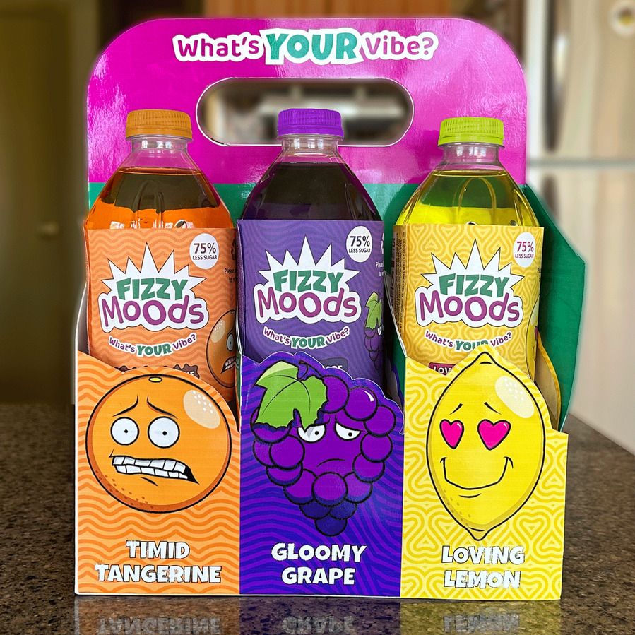 Variety pack on kitchen counter displaying the flavours Timid Tangerine, Gloomy Grape, and Loving Lemon. Tagline, "What's your vibe?" is placed along the handle.