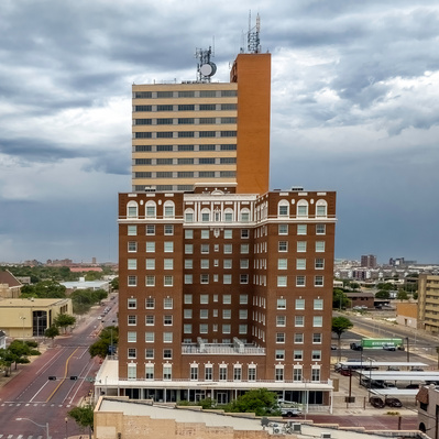 Drone photograph of, background, Metro Tower, foreground dark brick is the Pioneer Pocket Hotel, Lubbock, Texas