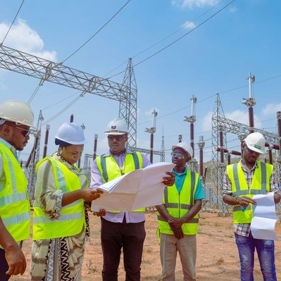  Engineers reviewing plans on the Powerline Project under construction 