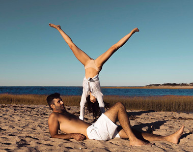 Couples photo: girl is doing cartwheel on the beach on cape Cod. Photography by Ivan Djikaev/Mind On Photography