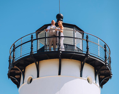Wedding photos: a couple on top of a lighthouse. Edgartown, Martha's Vineyard. Photography by Ivan Djikaev/Mind On Photography