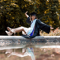 Bentley graduate sitting on a fountain in Boston Public garden