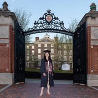 A Brown University graduate in front of Van Wickle Gates in Providence, RI
