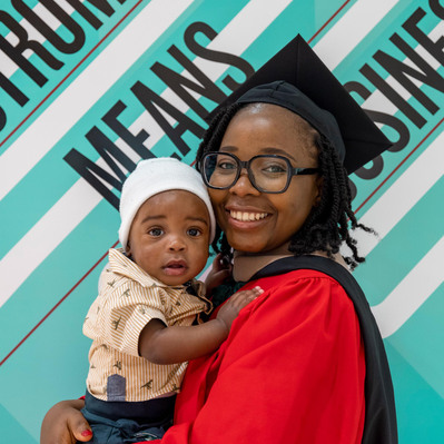 Grad with baby graduation day photo Boston
