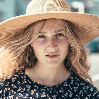 Headshot photography of woman in a hat on Cape Cod. Photographer Ivan Djikaev/Mind On Photography.