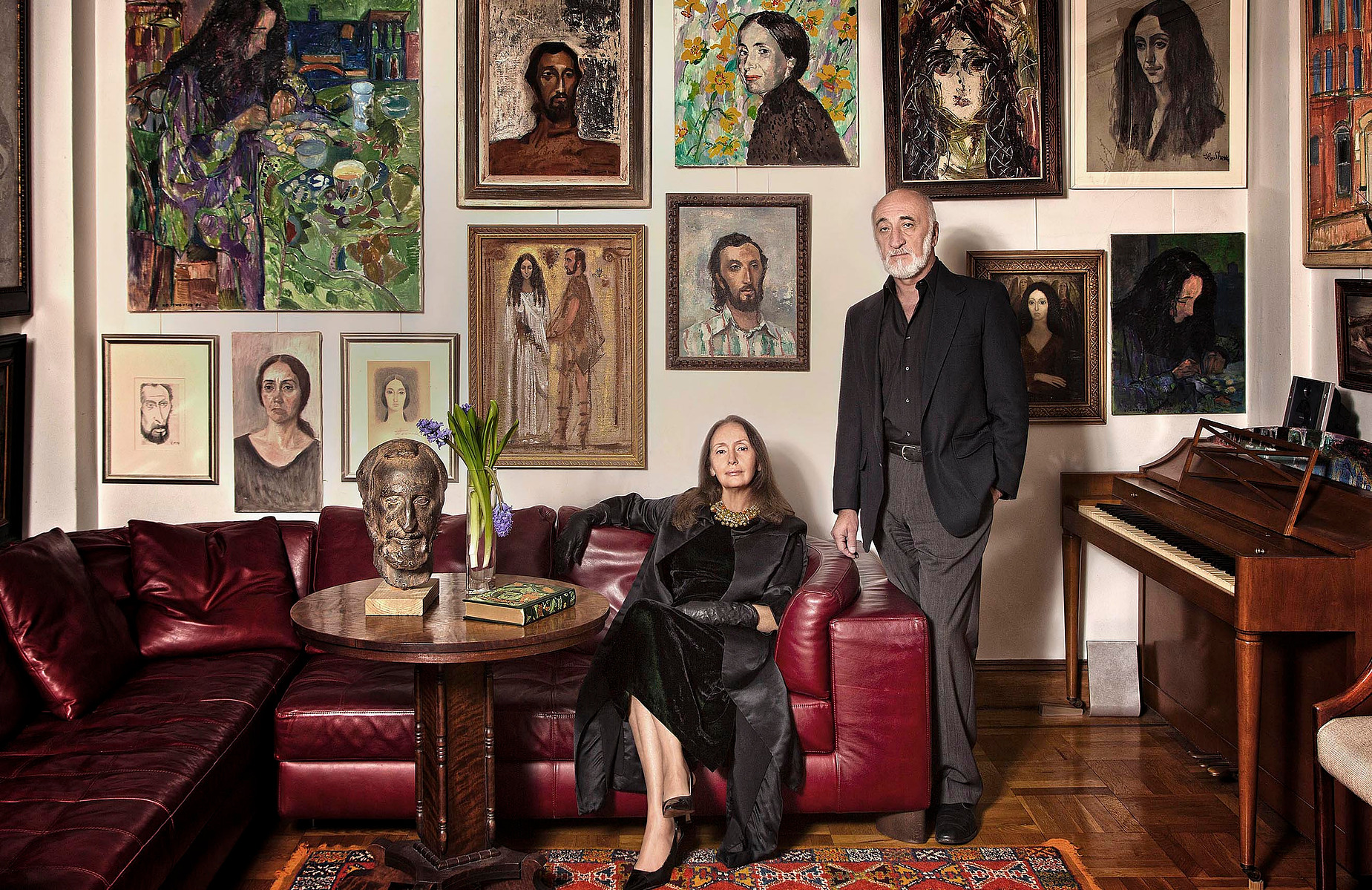 A portrait of a couple in a room with paintings, family portrait by Ivan Djikaev / Mind On photography