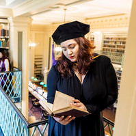 Graduation photo of friends in a library