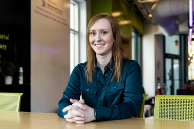 Woman sitting at a table professional headshot photography Boston