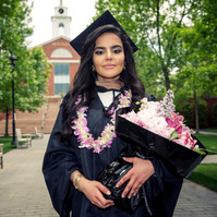 Bentley graduate with a bouquet