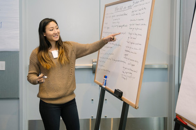 Woman presenting during event in Boston