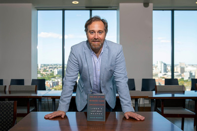 Author in desk with a book corporate photography Boston