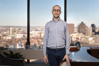 Man in office with the Boston downtown view corporate photo 