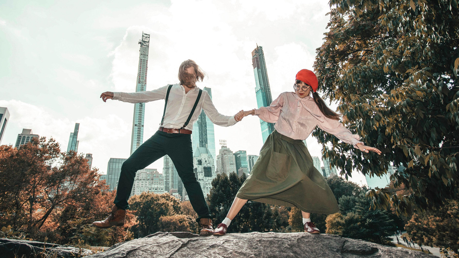 Stylish couple posing silly in Central Park in NYC. Engagement photographer Ivan Djikaev/Mind On Photography.