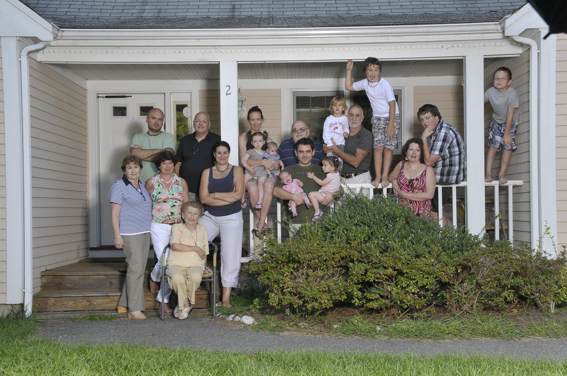 Large family group photograph on a porch