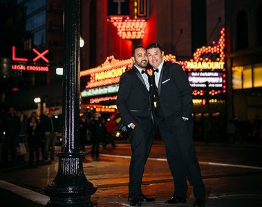 A newly eloped same sex couple on Washington Street in Boston at night