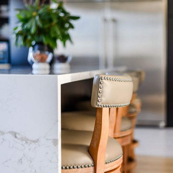 Waterfall kitchen island, quartz kitchen island, kitchen design idea, kitchen designer Connecticut, Leather counter stools with nailheads, natural walnut wood finish