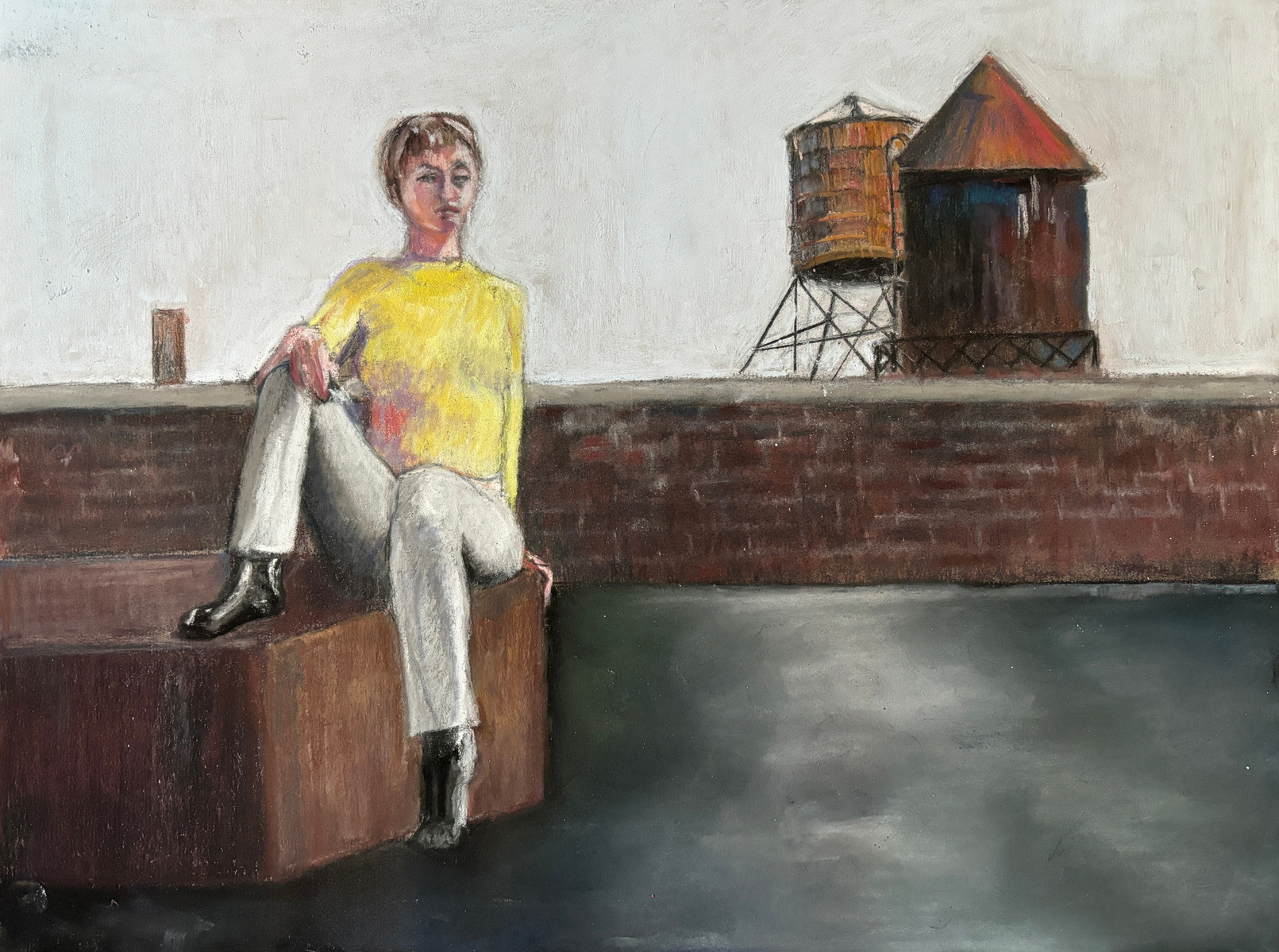 Woman wearing a yellow sweater sitting alone on a rooftop on a dreary day