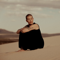 a buddhist monk photographed by Cari Faye Antonovich of The White Room Studios at the Seminoe sand dunes near Rawlins Wyoming at sunset