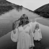 Ranch Reverie
From the studio, we transitioned to a friend’s ranch located off Hat Six Road, a setting that promised natural beauty and a golden-hour glow that only Wyoming can offer. The ranch was the perfect backdrop for Isis’s diverse wardrobe changes,