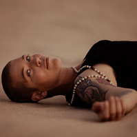 a buddhist monk photographed by Cari Faye Antonovich of The White Room Studios at the Seminoe sand dunes near Rawlins Wyoming at sunset