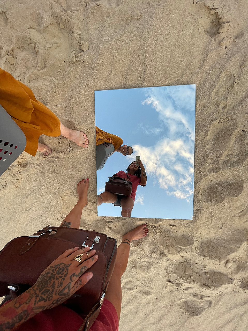 behind the scenes photo of a portrait session with Cari Faye photography at the Seminole sand dunes in Wyoming where she photographed a buddhist monk with a mirror