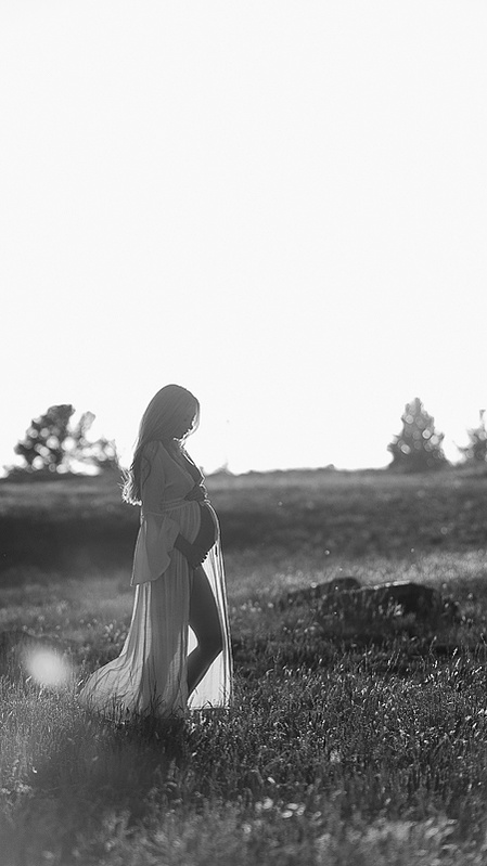 photograph of emmy Voigt of Casper Wyoming maternity portrait photographed by Cari Faye Antonovich of Cari Faye photography and the white room muddy mountain photoshoot sunset