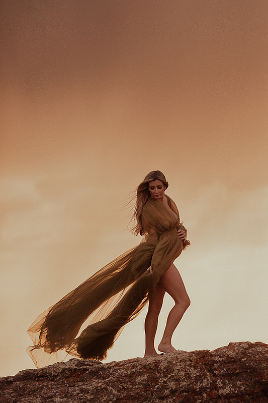 photograph of emmy Voigt of Casper Wyoming maternity portrait photographed by Cari Faye Antonovich of Cari Faye photography and the white room muddy mountain photoshoot sunset