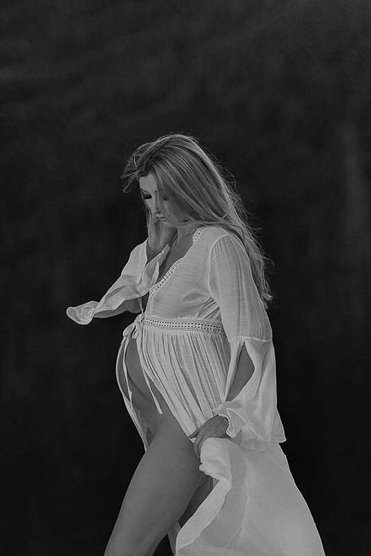 photograph of emmy Voigt of Casper Wyoming maternity portrait photographed by Cari Faye Antonovich of Cari Faye photography and the white room muddy mountain photoshoot sunset