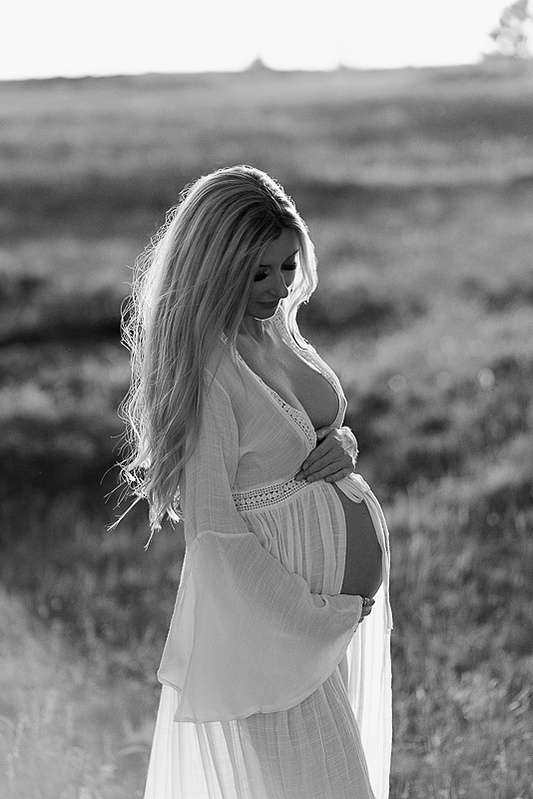 photograph of emmy Voigt of Casper Wyoming maternity portrait photographed by Cari Faye Antonovich of Cari Faye photography and the white room muddy mountain photoshoot sunset