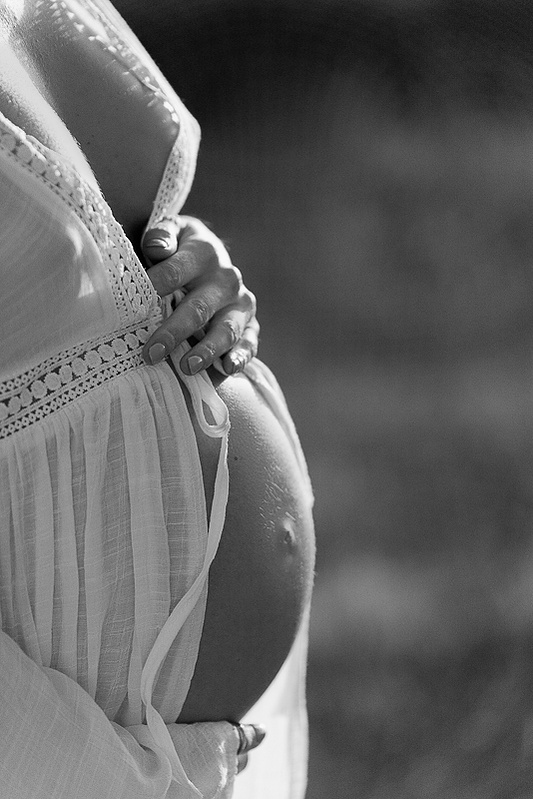 photograph of emmy Voigt of Casper Wyoming maternity portrait photographed by Cari Faye Antonovich of Cari Faye photography and the white room muddy mountain photoshoot sunset