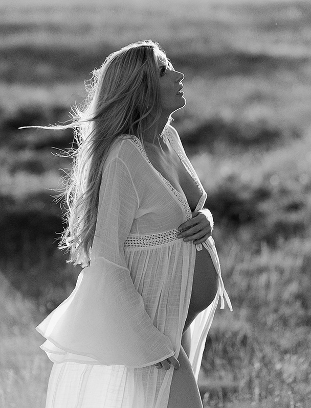 photograph of emmy Voigt of Casper Wyoming maternity portrait photographed by Cari Faye Antonovich of Cari Faye photography and the white room muddy mountain photoshoot sunset