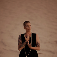 a buddhist monk photographed by Cari Faye Antonovich of The White Room Studios at the Seminoe sand dunes near Rawlins Wyoming at sunset