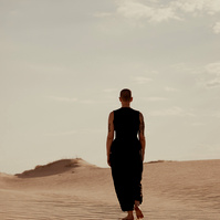 a buddhist monk photographed by Cari Faye Antonovich of The White Room Studios at the Seminoe sand dunes near Rawlins Wyoming at sunset. Dune vibes