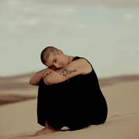 a buddhist monk photographed by Cari Faye Antonovich of The White Room Studios at the Seminoe sand dunes near Rawlins Wyoming at sunset