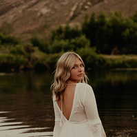 Ranch Reverie
From the studio, we transitioned to a friend’s ranch located off Hat Six Road, a setting that promised natural beauty and a golden-hour glow that only Wyoming can offer. The ranch was the perfect backdrop for Isis’s diverse wardrobe changes,