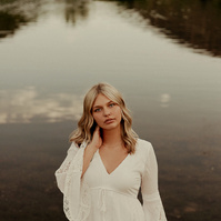 Ranch Reverie
From the studio, we transitioned to a friend’s ranch located off Hat Six Road, a setting that promised natural beauty and a golden-hour glow that only Wyoming can offer. The ranch was the perfect backdrop for Isis’s diverse wardrobe changes,