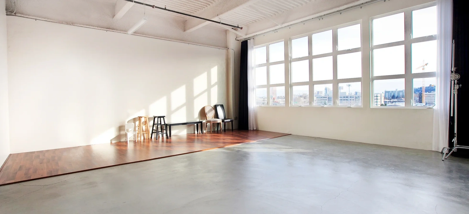 Wide open space of a natural light studio with grid windows