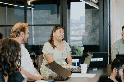 An employee addressing her co-workers during a work meeting