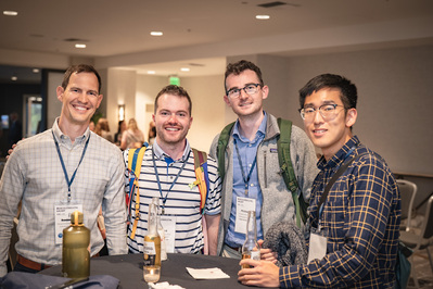 Four men having a drink together at the end of their AAPA conference