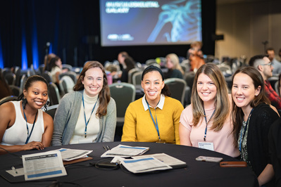 Group of women sitting together at a conference for AAPA

