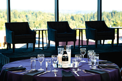 A well decorated table with a stage for speakers behind it - In the event space, Ironlight