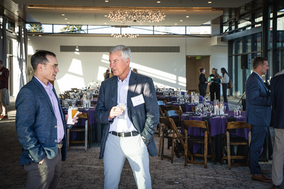 Two men talking inside of an event space, Ironlight, in Lake Oswego